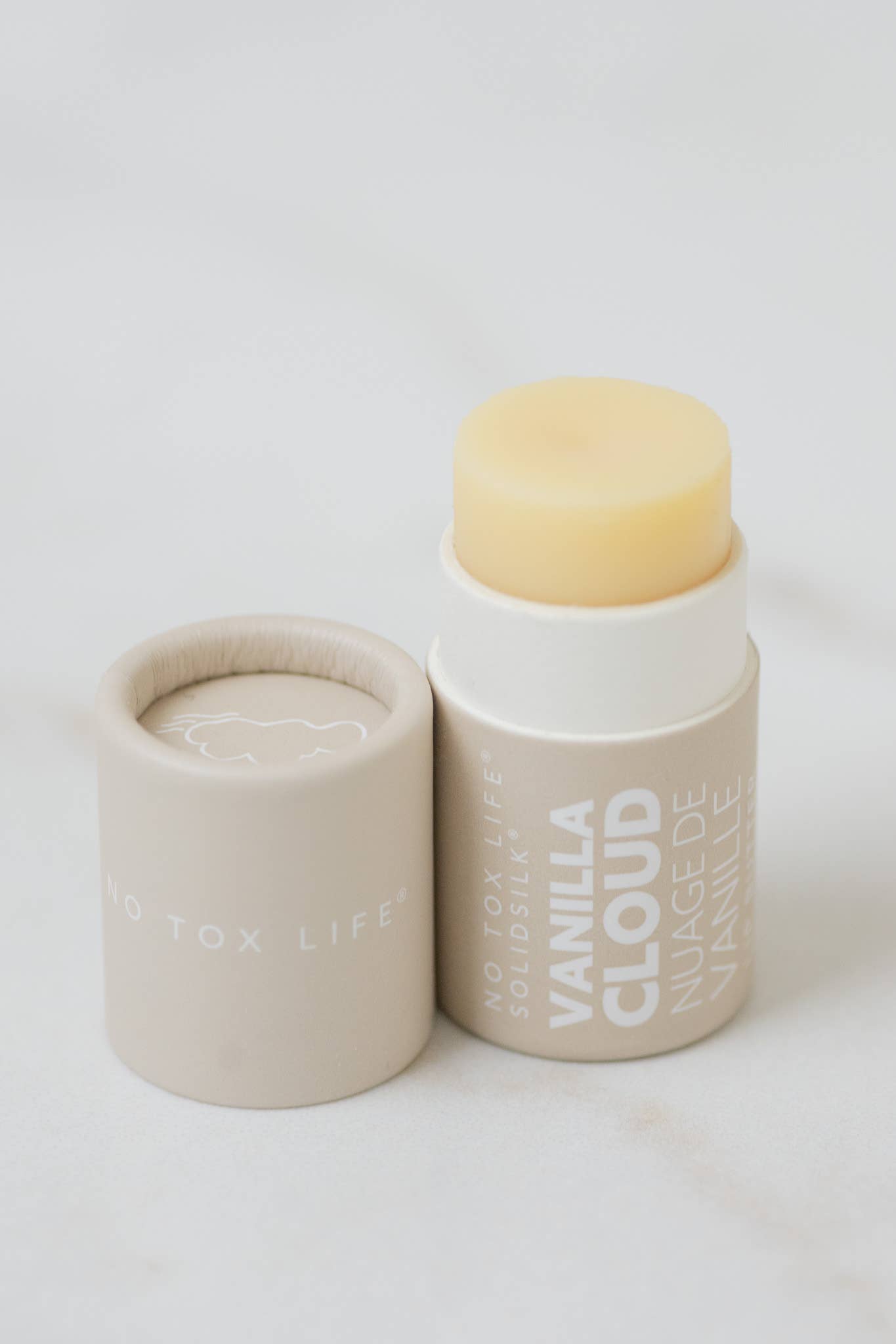Vanilla cloud product with beige lid on a white background