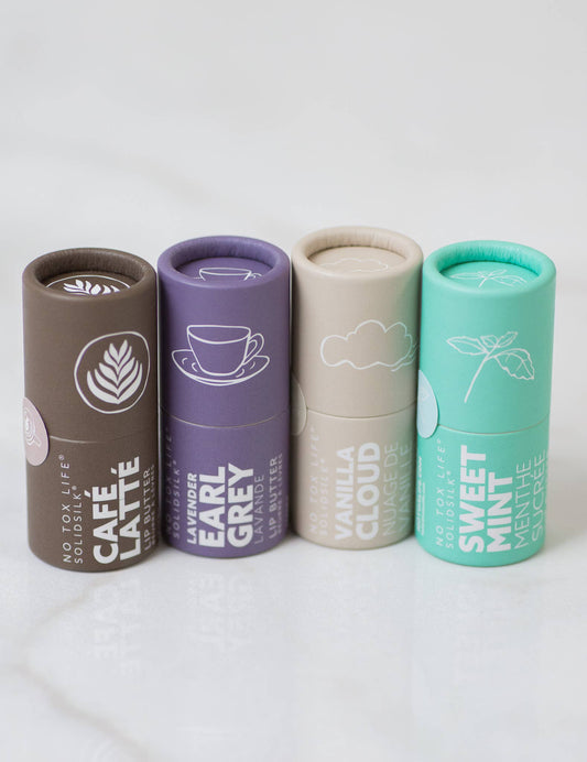 Four cylindrical containers with different flavors on a white background