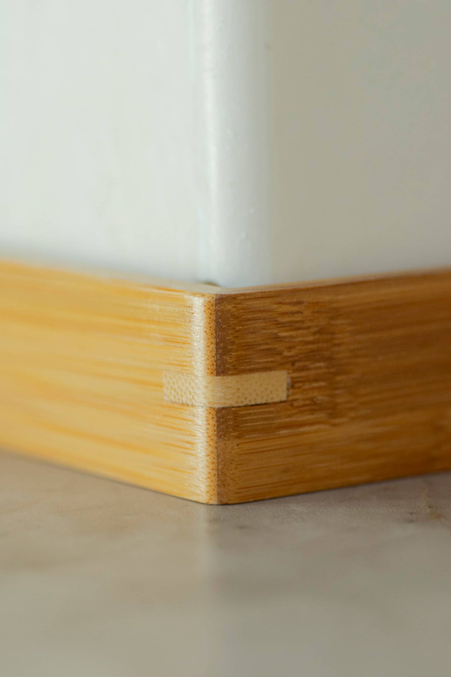 Corner view of wooden soap holder. 