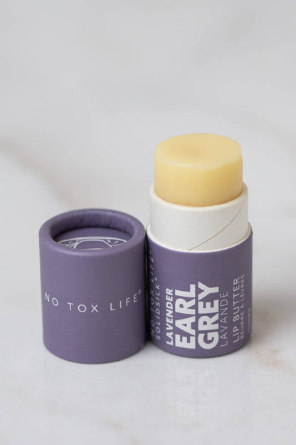 Lavender Earl Grey lip butter with packaging on a light background