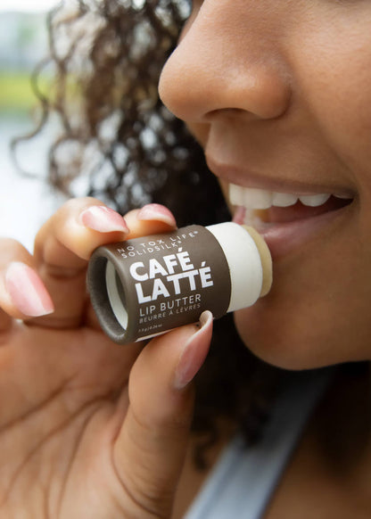 Person applying Café Latté lip butter to their lips.