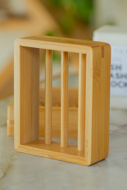A wooden bamboo soap holder standing vertically on white surface. 