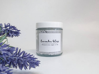 Jar of lavender bliss whipped sugar scrub with lavender flowers on a white background
